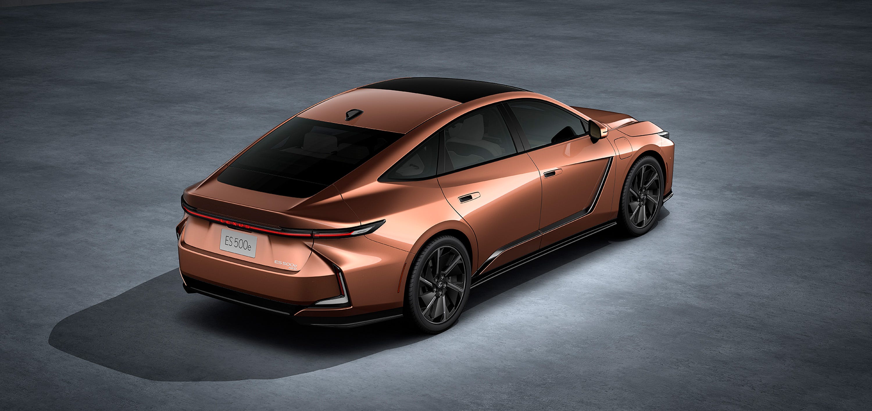 rear three quarter view of a bronze sedan featuring a black roof, led taillight bar, and black alloy wheels.