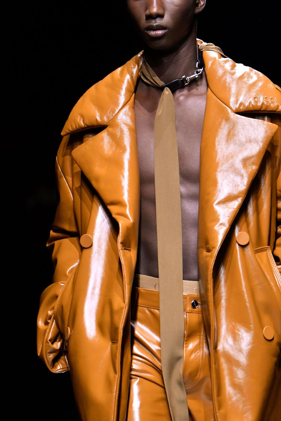 a man wearing a gold jacket