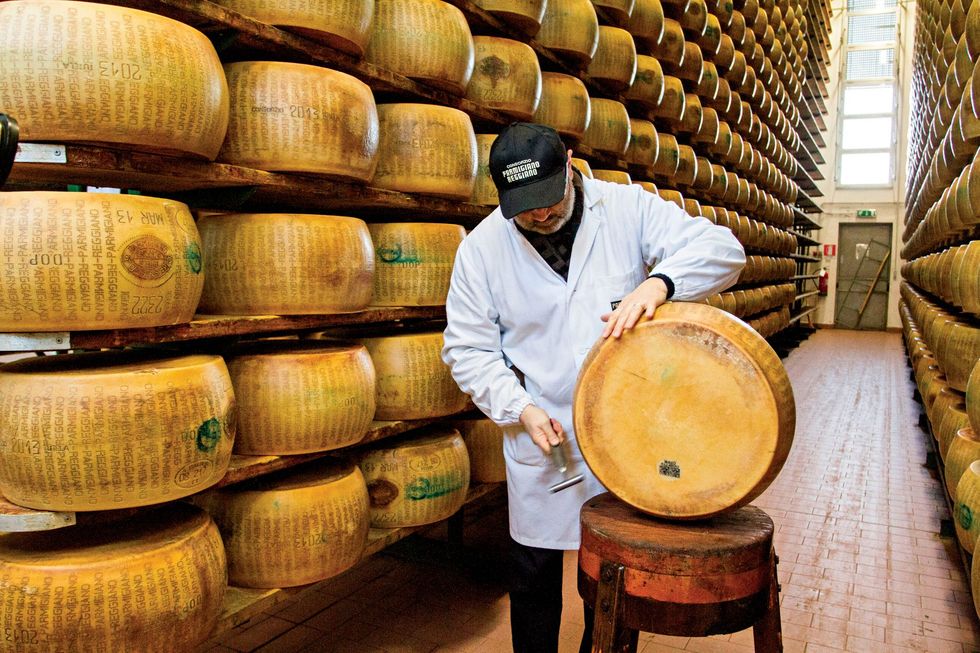 Een deskundige van het Italiaanse ParmigianoReggiano Consortium test de kwaliteit van de ParmigianoReggiano