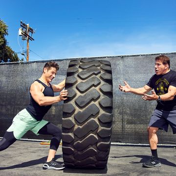 ferrigno father and son exercising with tire