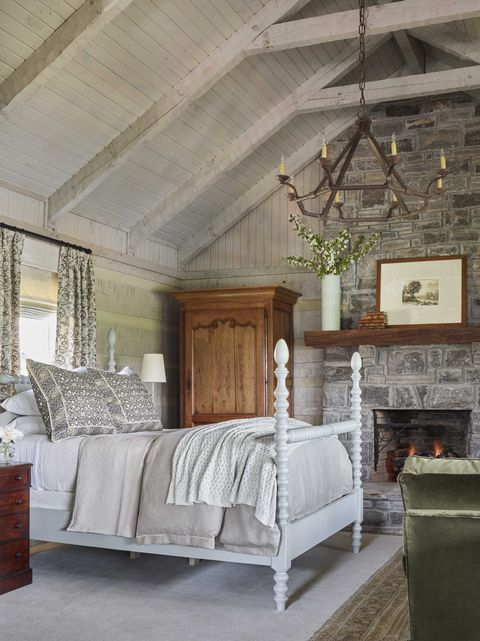 bedroom, stone fireplace, white bedfram, gray bed linen