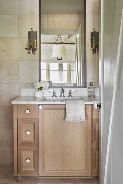 bathroom, wooden cabinets, white countertops