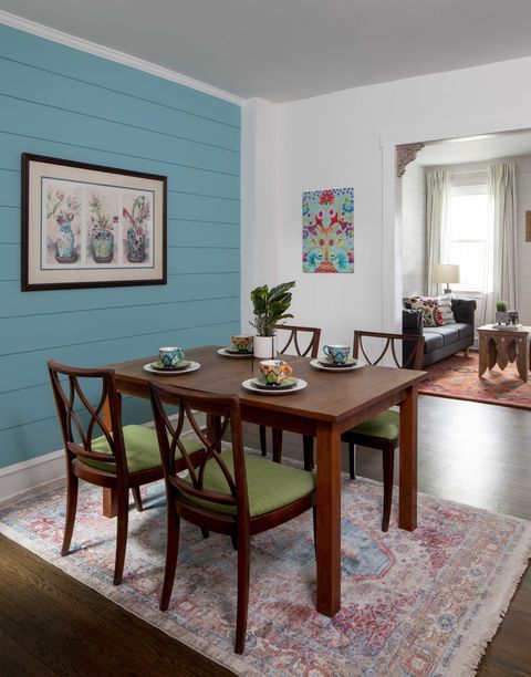 dining room, dining wooden dining table with wooden and green cushioned dining chairs, rug, blue shiplap wall