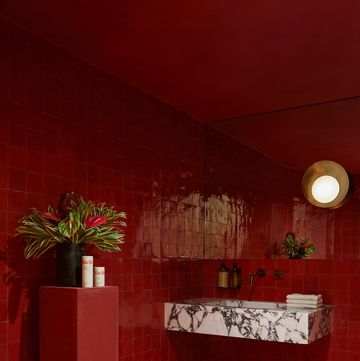 a bathroom with a red tile floor