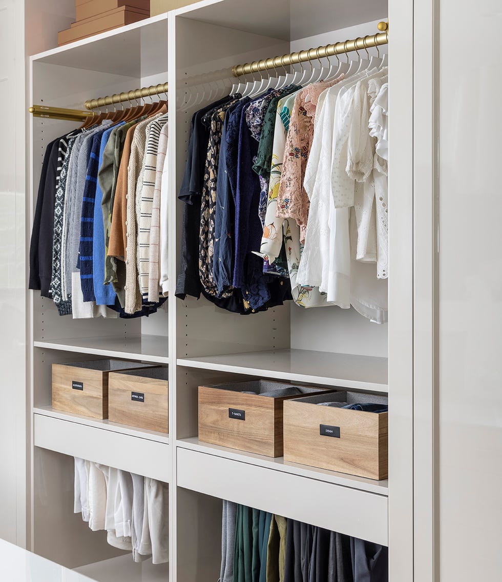 organized closet with gold rod and wood bins