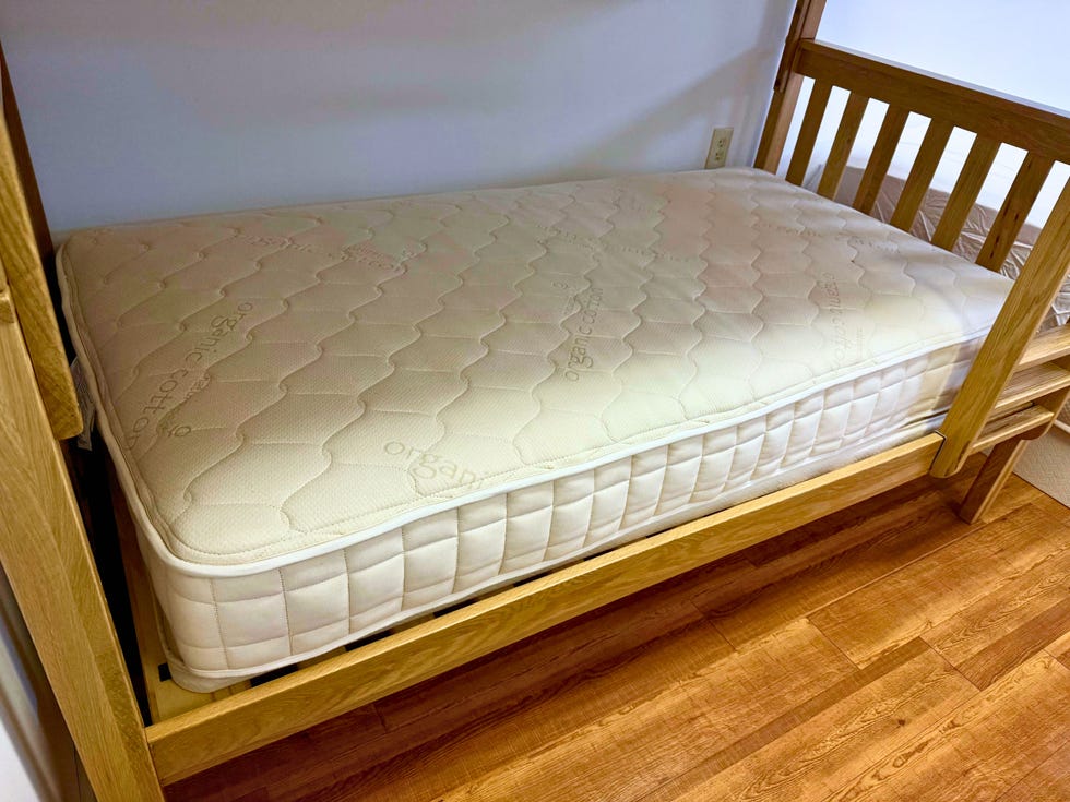 a naturepedic kids mattress on a wooden bunk bed frame