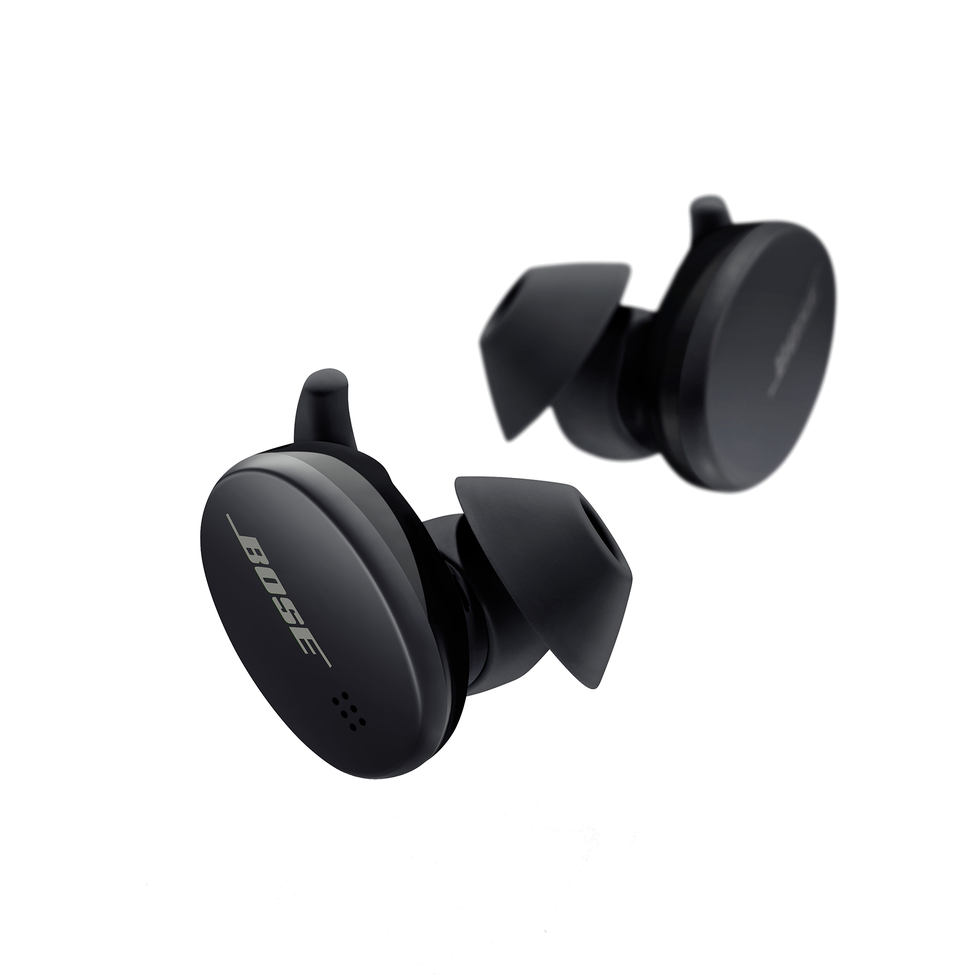 man using wireless earphones air pods on running outdoors active lifestyle concept