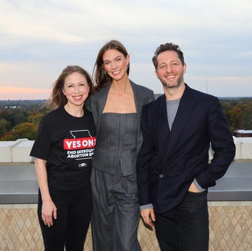 group of three people posing on a rooftop at sunset group of three people posing on a rooftop at sunset