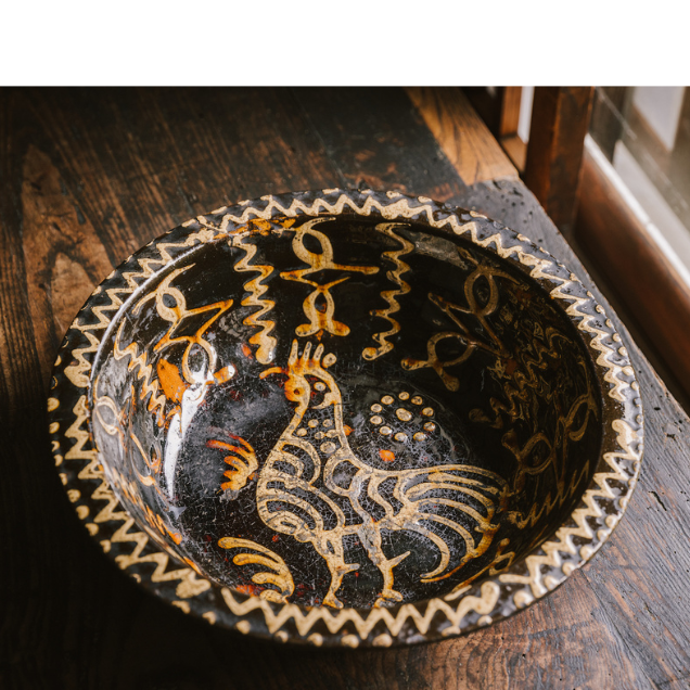 a wood bowl with a bird design