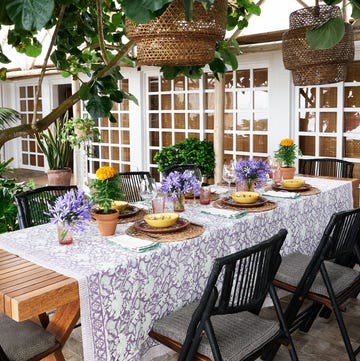 a table with chairs and plants on it