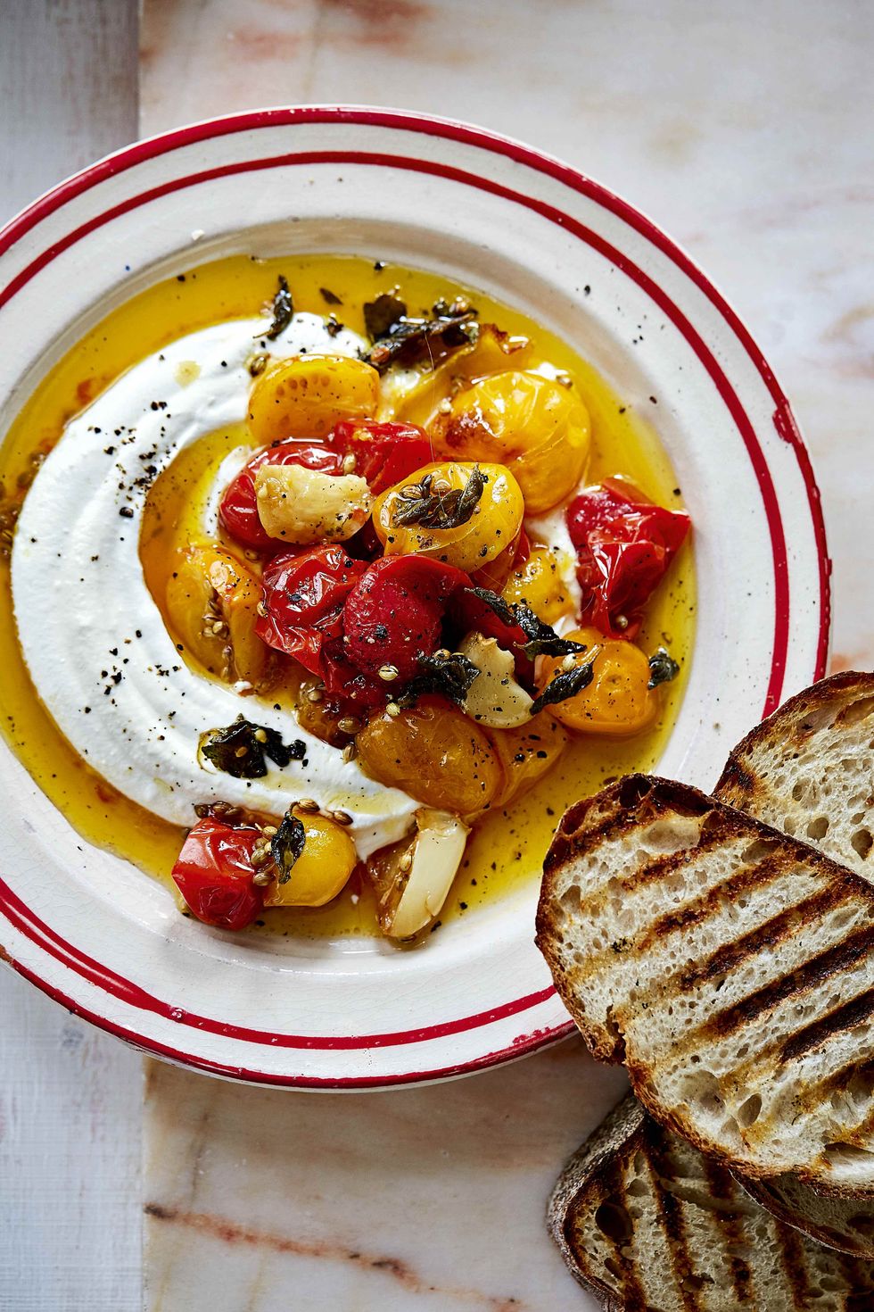 a whipped feta and confit tomatoes dish featured in bhogal's new book
