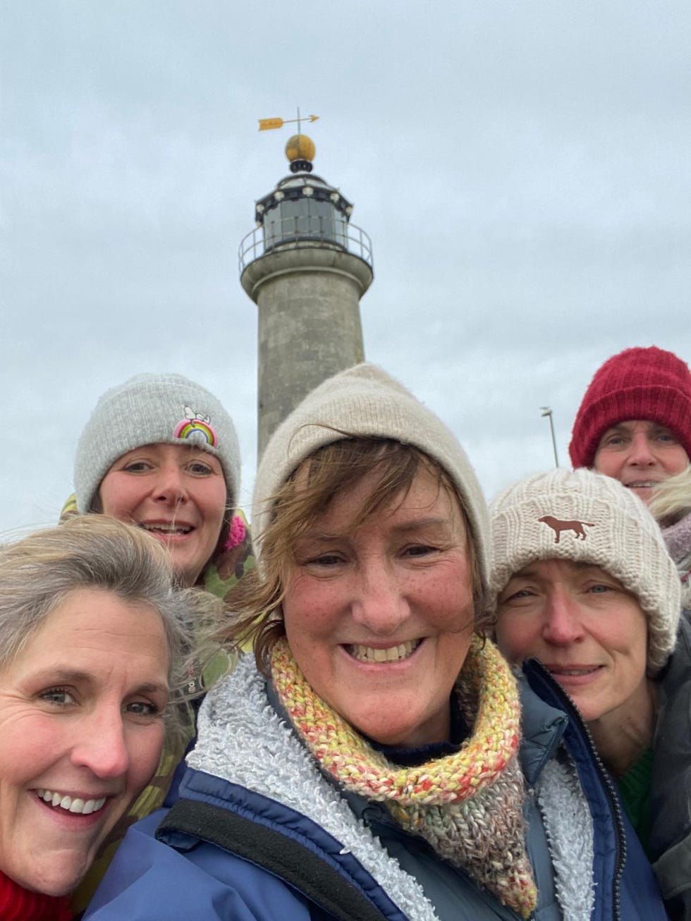 group photo taken near a lighthouse