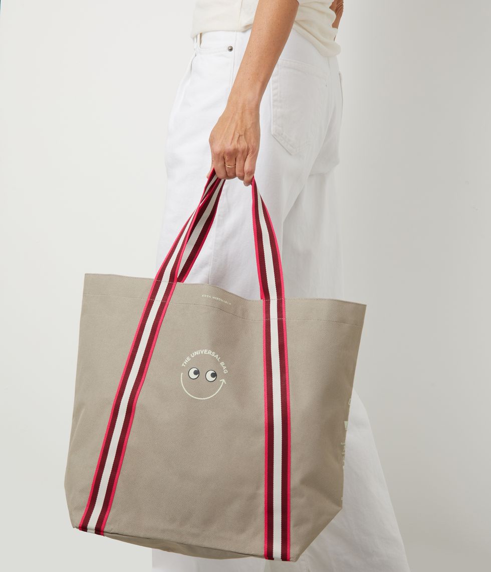 a person holding a red and white bag