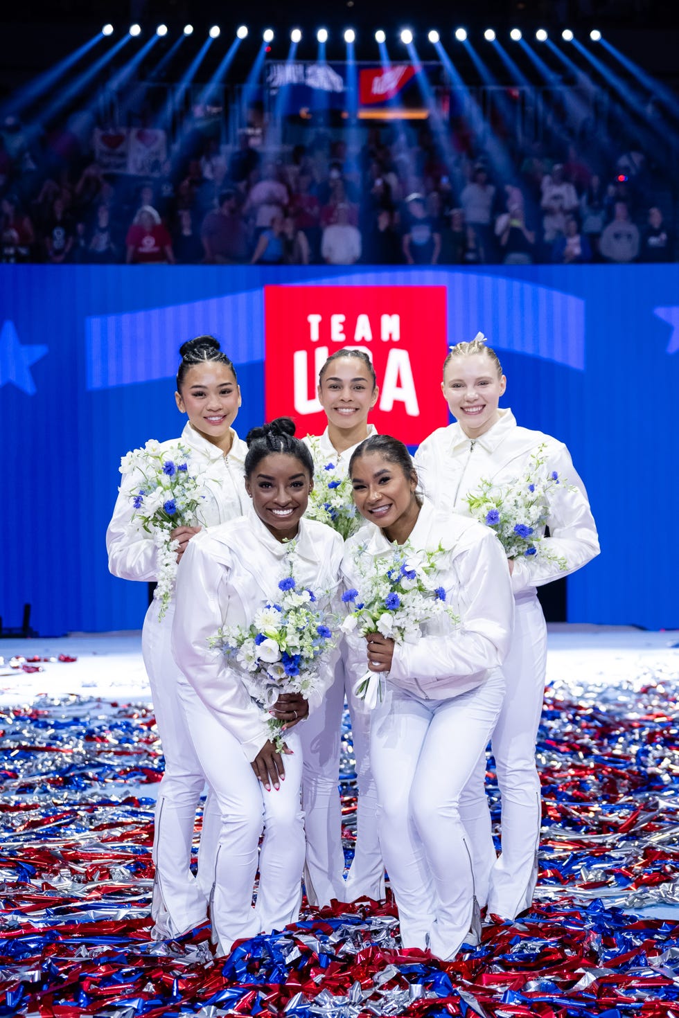 a group of people in white outfits