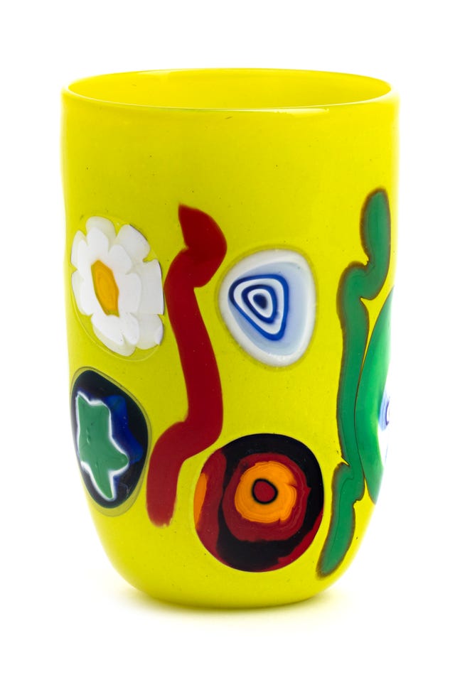 decorative yellow cup with vibrant multicolored patterns