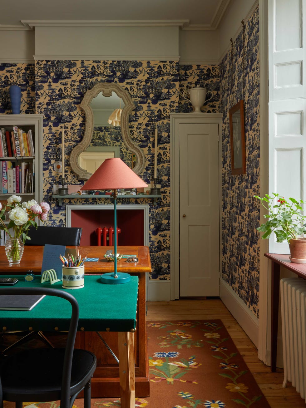 an office with patterned wallpaper and desks