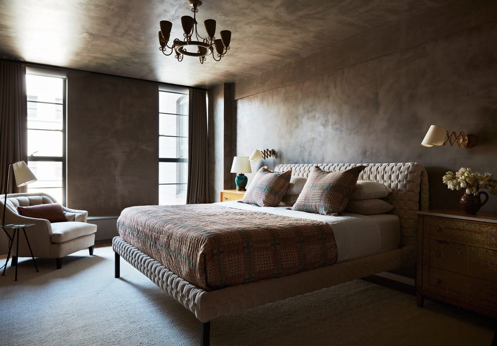 a bedroom with a bed and a chair