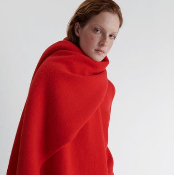 a model wearing a vibrant red shawl showcasing a minimalist design a model wearing a vibrant red shawl showcasing a minimalist design