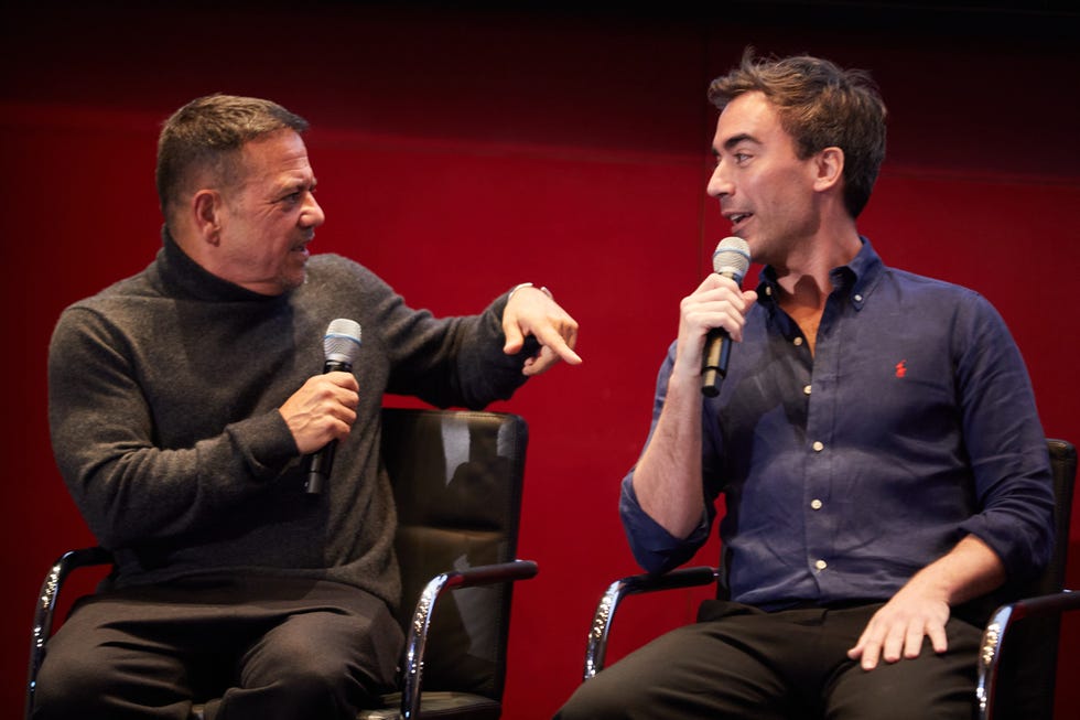 a couple of men sitting in chairs