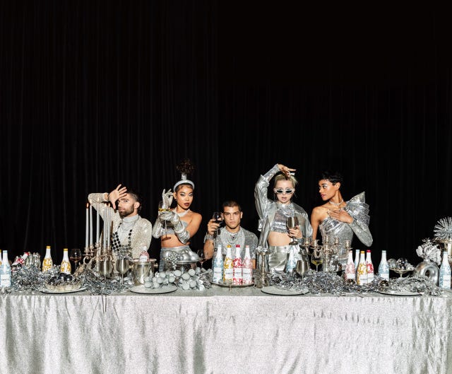silver tablescape with modesl and wine bottles