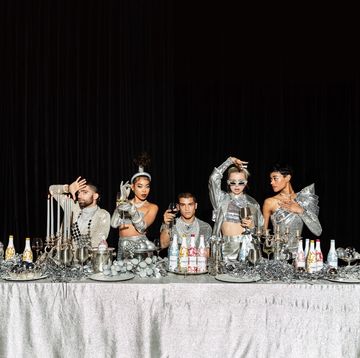 silver tablescape with modesl and wine bottles