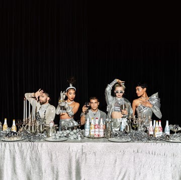 silver tablescape with modesl and wine bottles silver tablescape with modesl and wine bottles