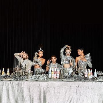 silver tablescape with models and wine bottles
