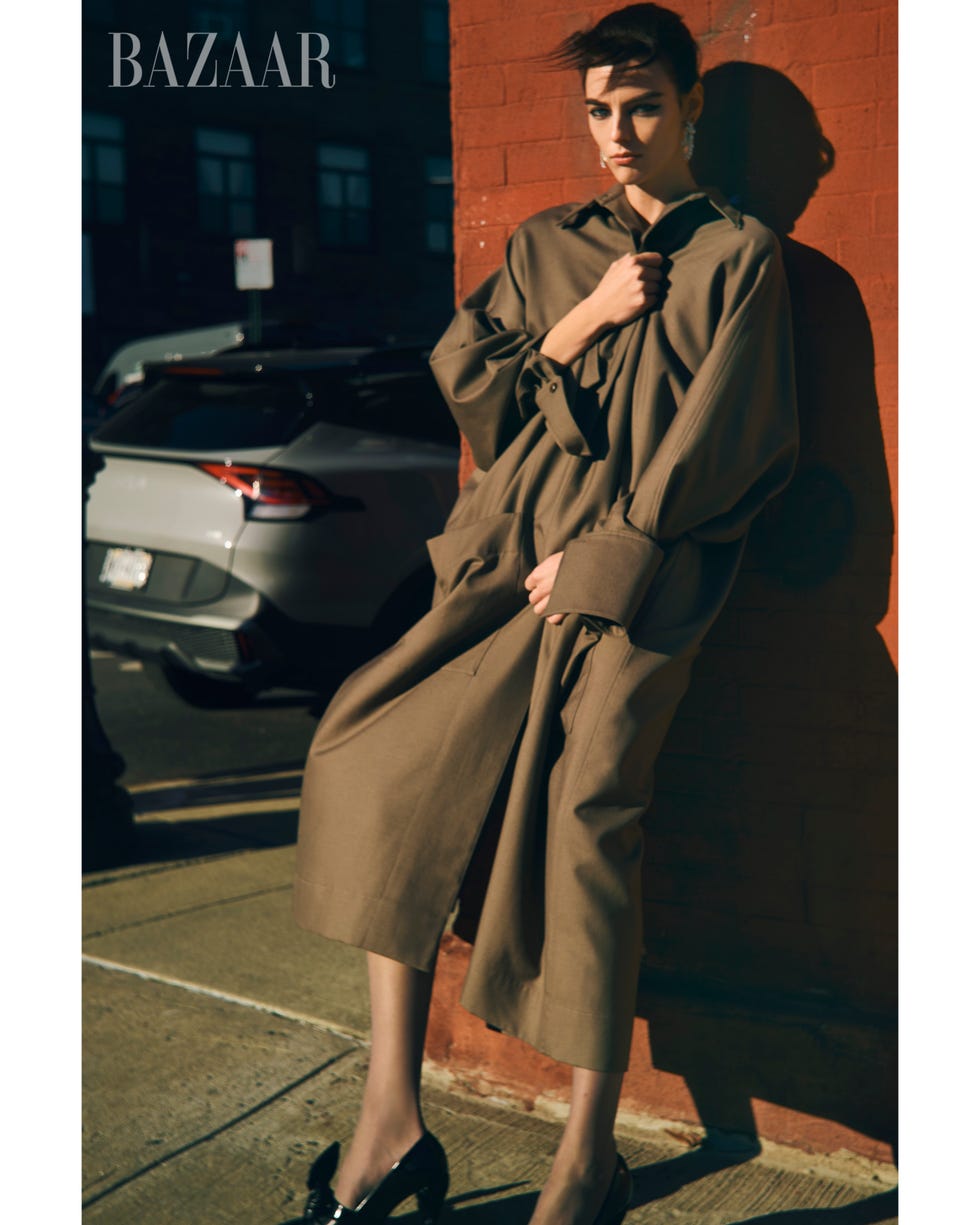 a person wearing a long coat and a hoodie