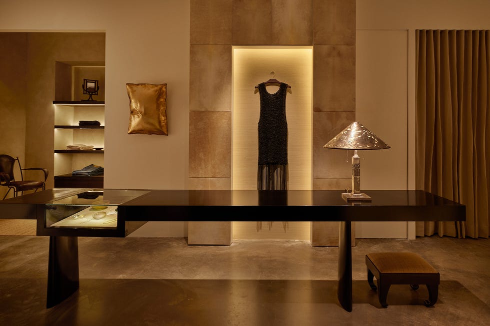 Fashion display with clothing and decorative elements in a modern room.
