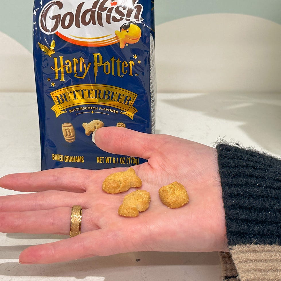 butterbeer flavored goldfish snacks in a hand near their packaging