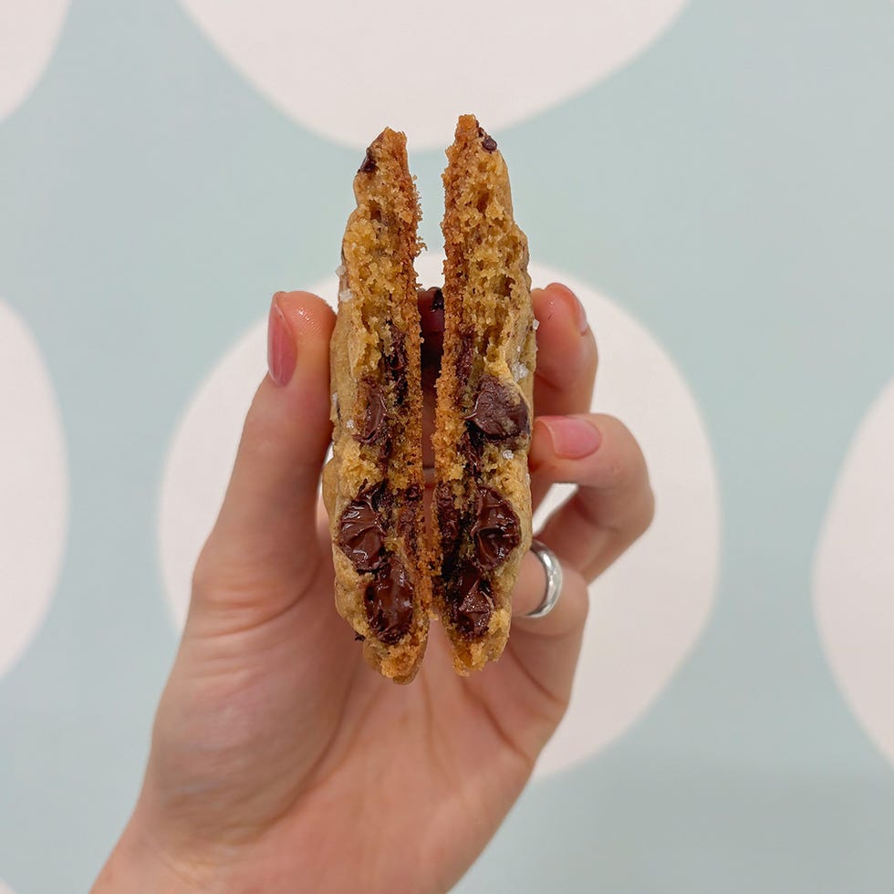 halved chocolate chip cookie showcasing gooey chocolate filling