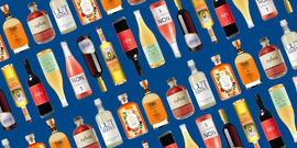 arranged assortment of various non alcoholic beverage bottles against a blue background