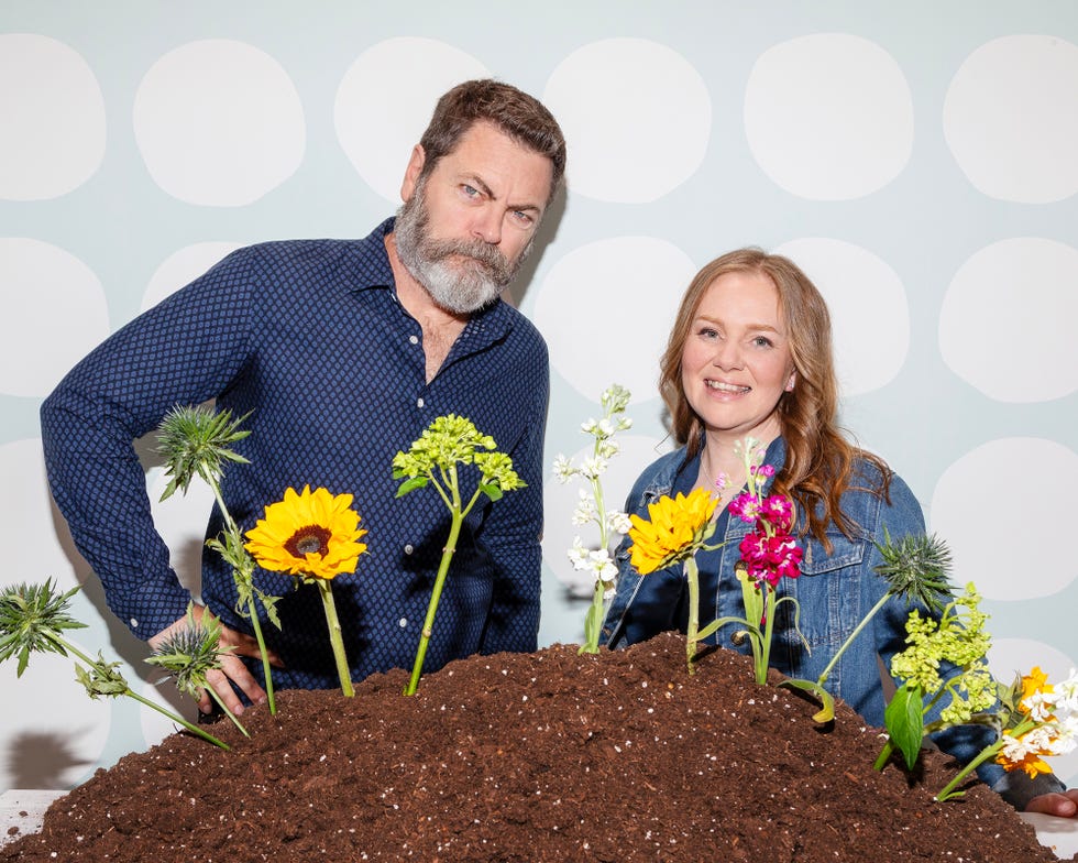 a man and a woman holding flowers