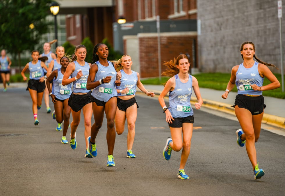 group of runners participating in a race on a street