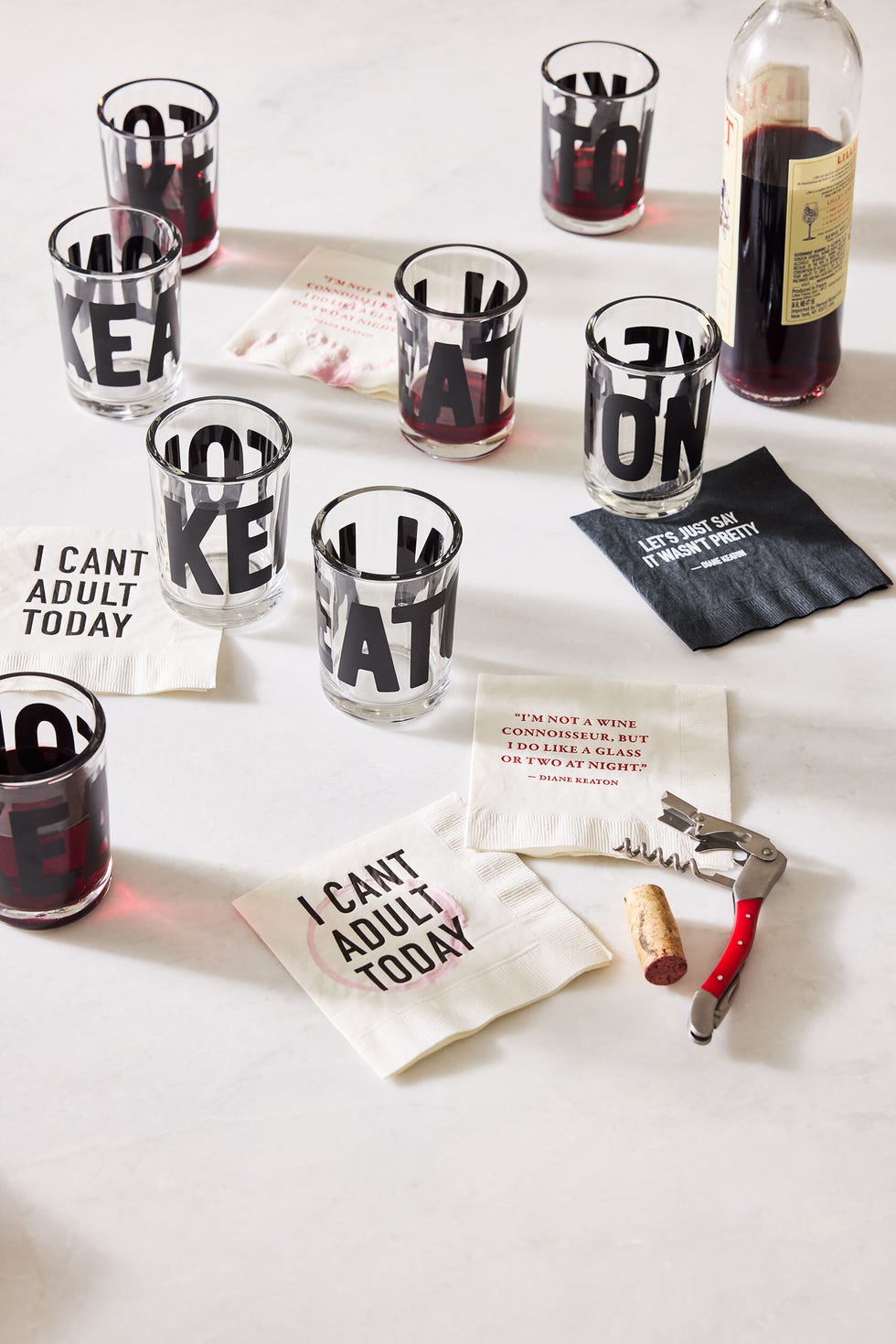 a set of glasses and cocktail napkins