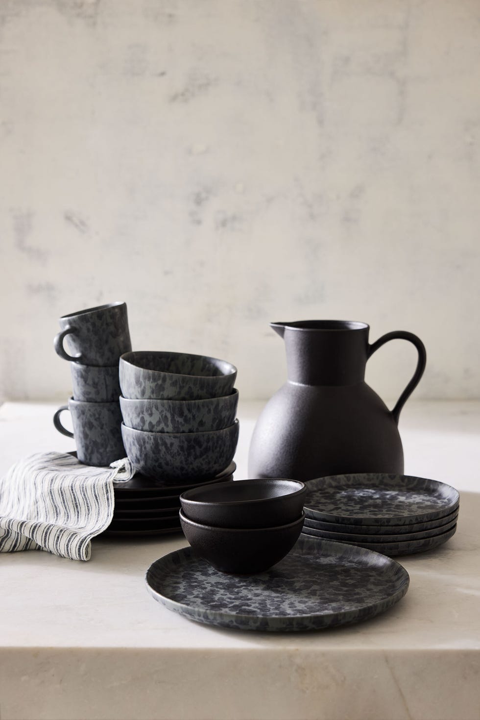 a set of black cups and bowls