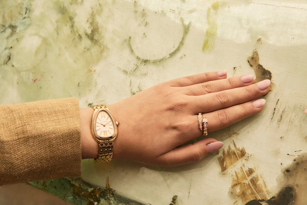 a hand with a gold watch