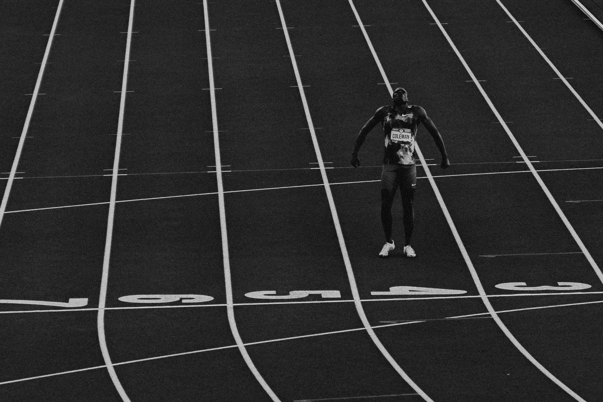 a single runner celebrates on a track