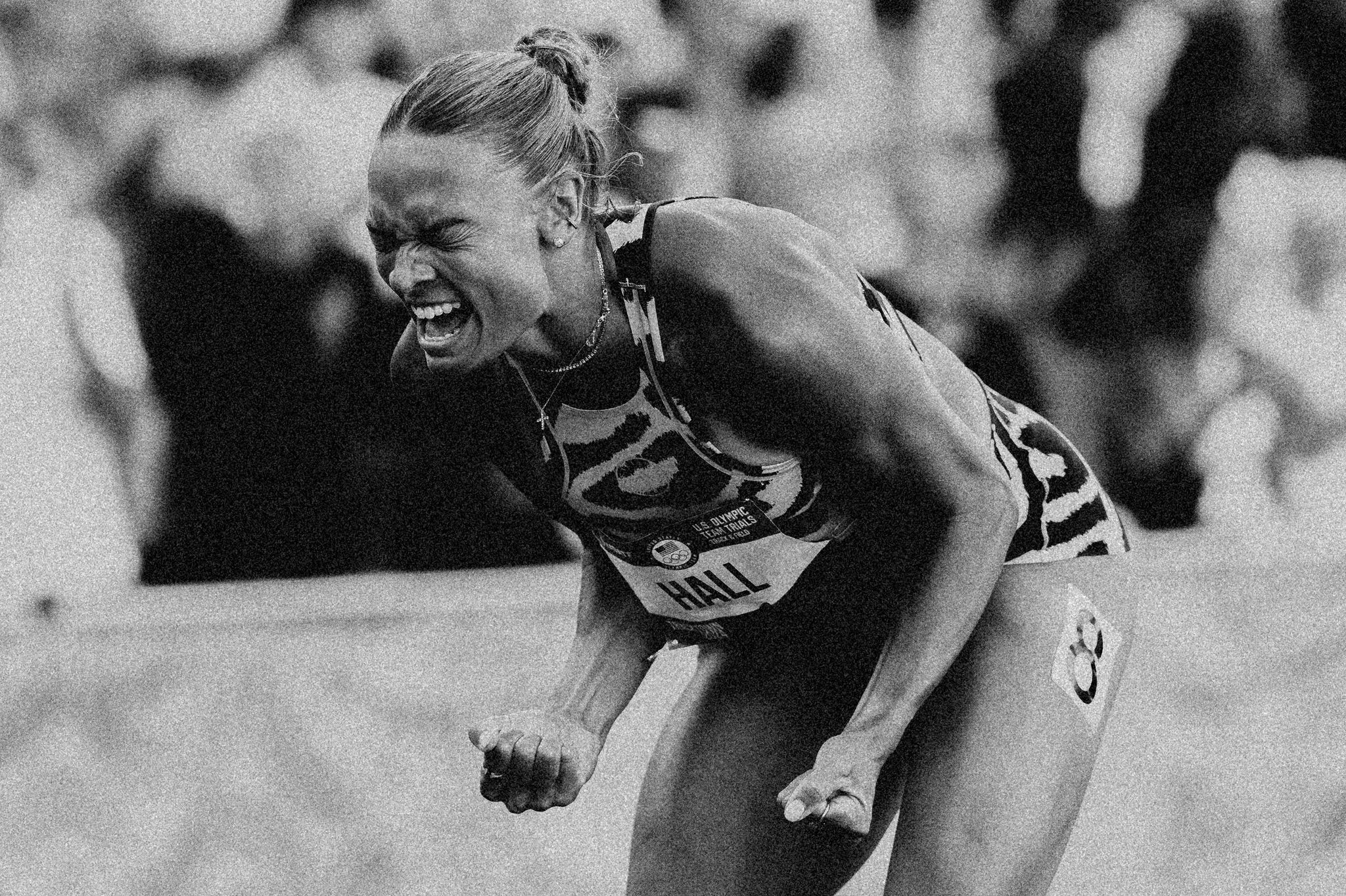 a woman track and field athlete celebrates