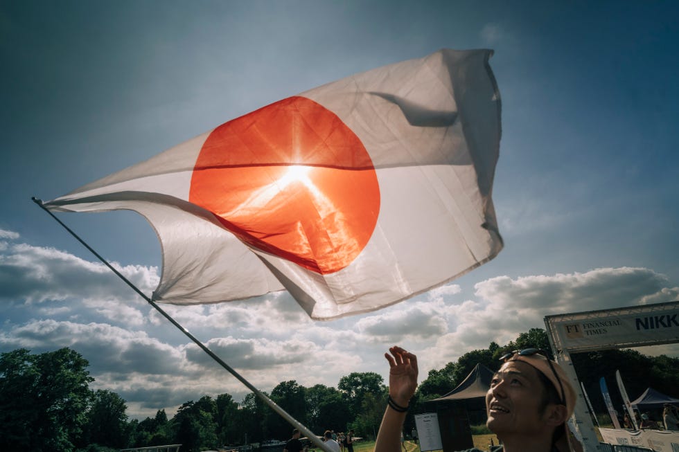 person waving a japanese flag