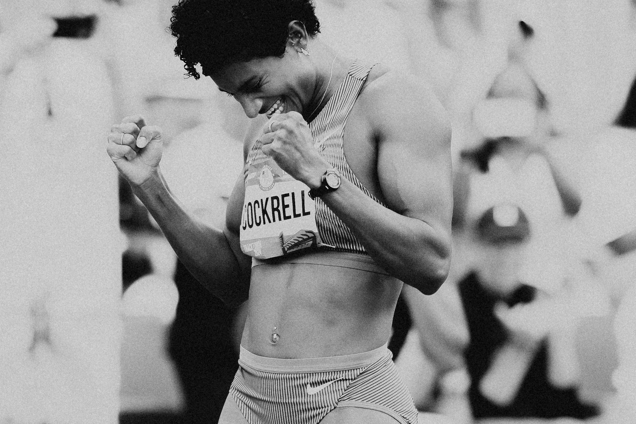 a woman track athlete celebrates a woman track athlete celebrates