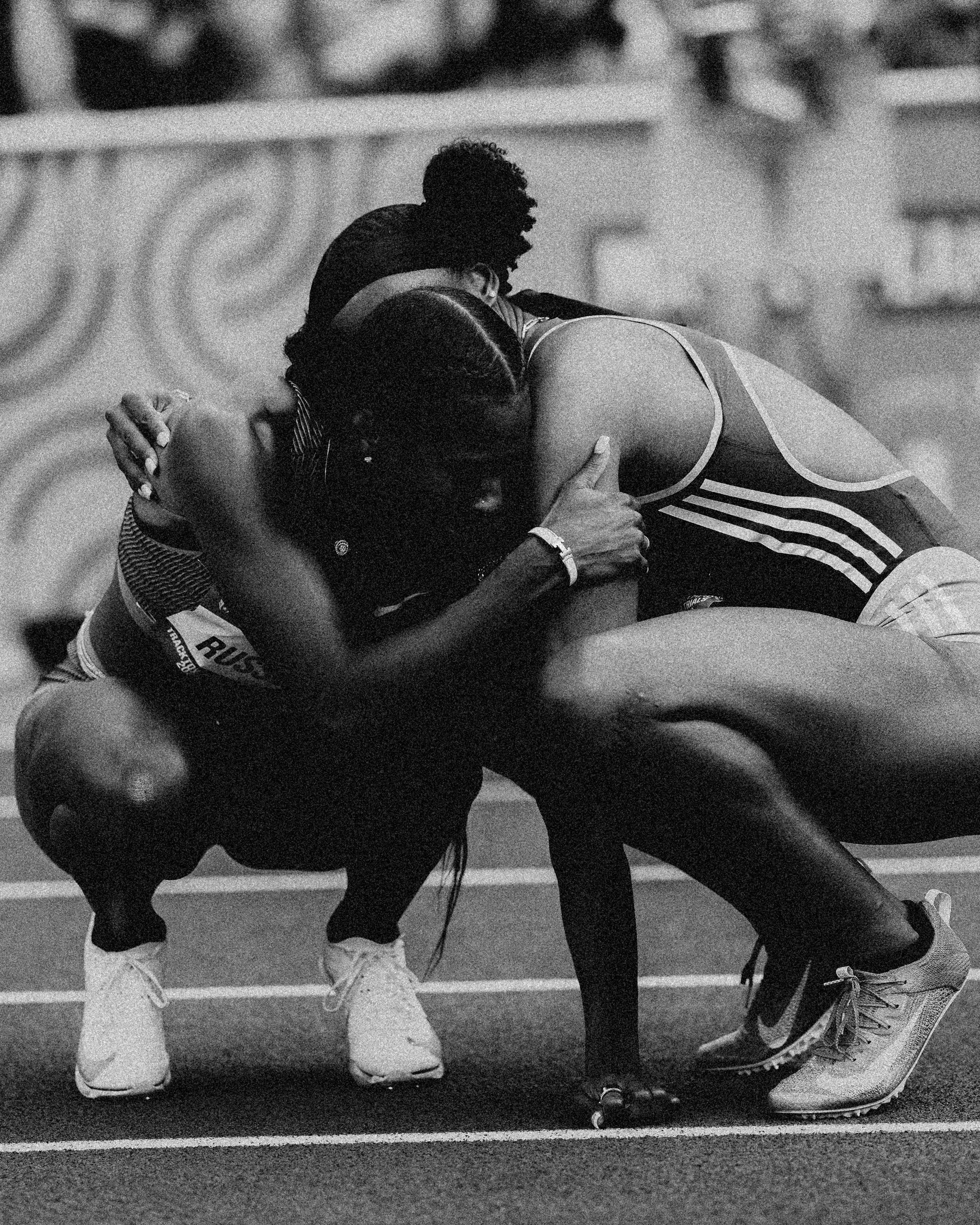 two women track athletes hug after a race