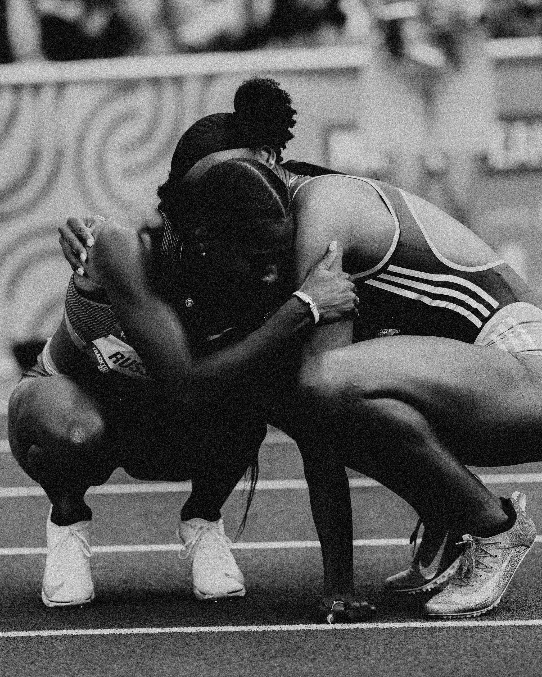 two women track athletes hug after a race two women track athletes hug after a race