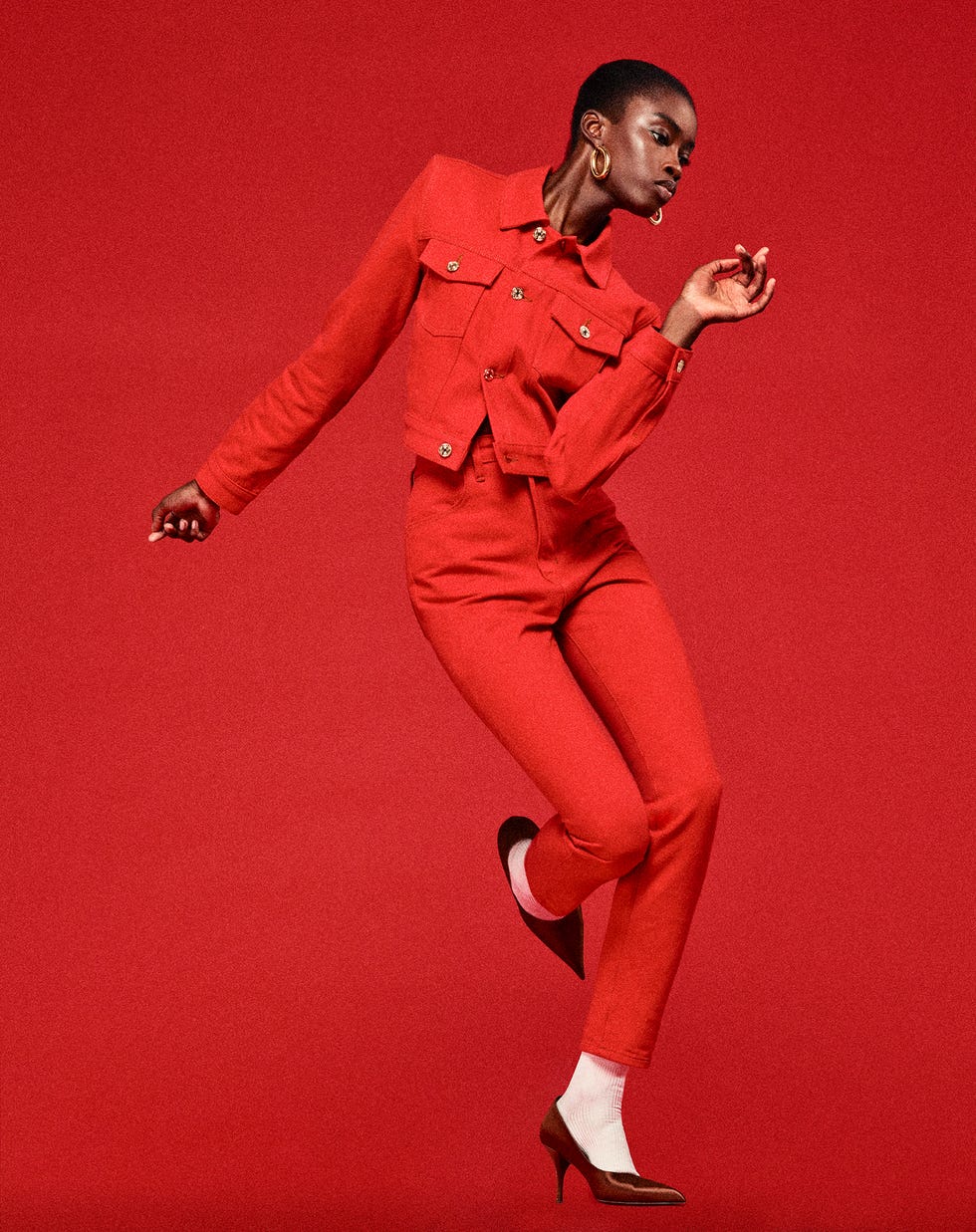 model wearing a red outfit against a red background