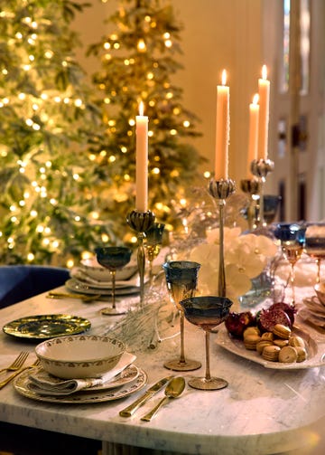 dinner setup with ombre glasses, plates, macarons, pomegranate ornaments, and other decorative touches