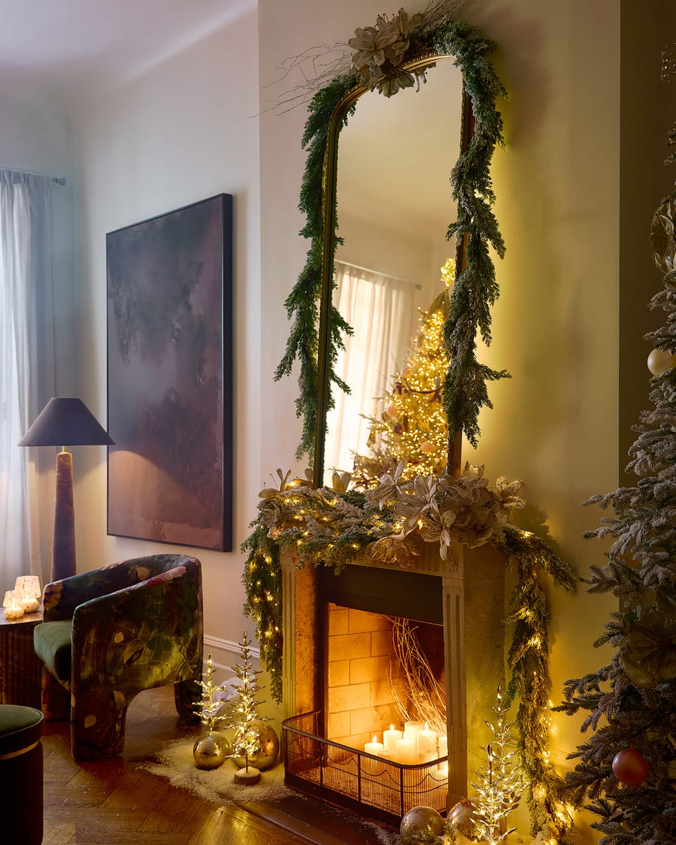 cozy living room with a decorated fireplace and christmas tree