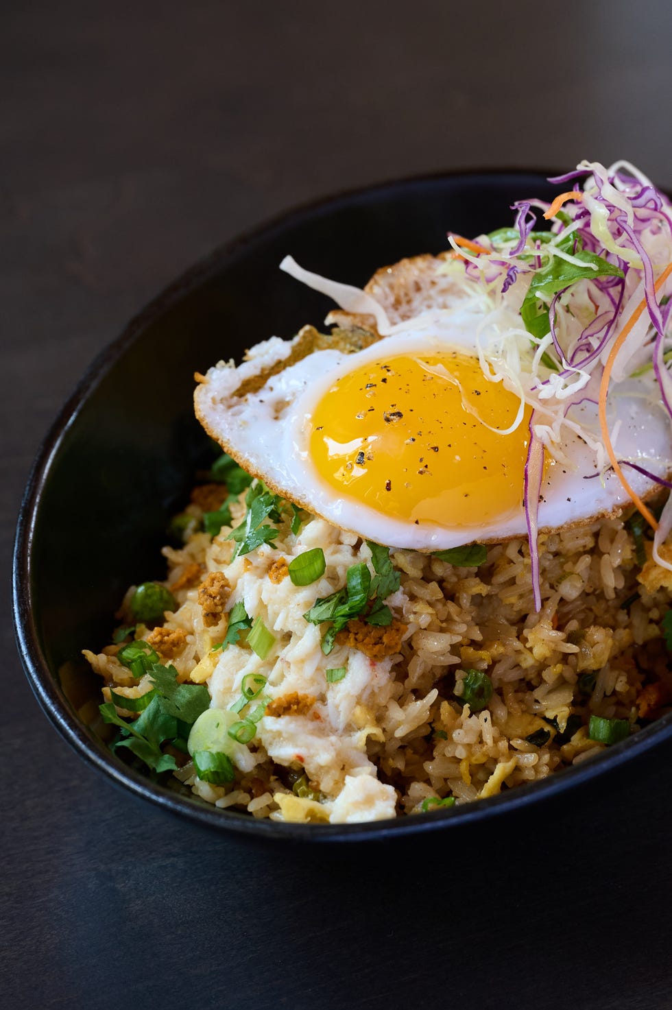 fried rice topped with a sunnysideup egg and garnished with vegetables