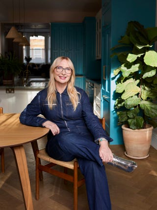 Person seated at a wooden table in a modern kitchen