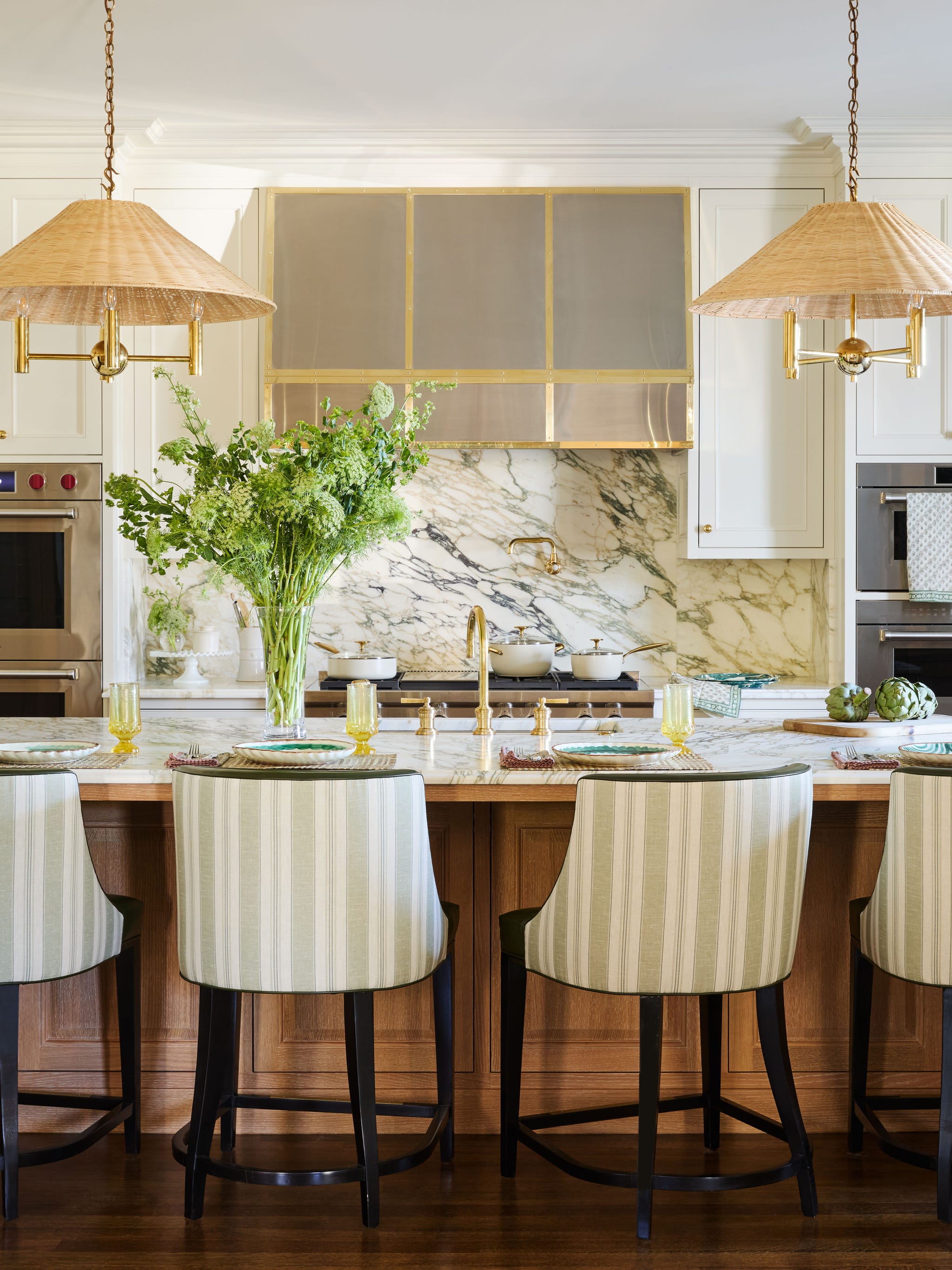 bromley samora st louis house tour kitchen oak cabinetry white marble countertops stripe counterstools