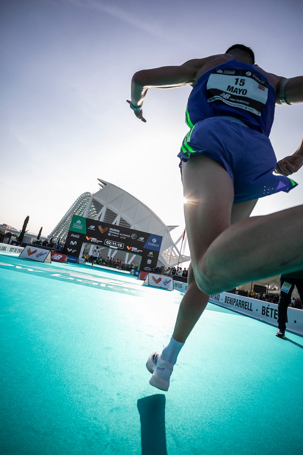 athlete in motion during a race under bright skies